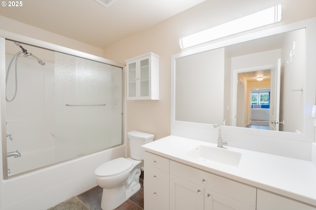 bathroom featuring toilet, visible vents, bath / shower combo with glass door, and vanity