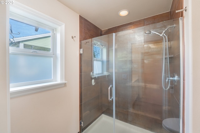 bathroom featuring a stall shower, plenty of natural light, and toilet