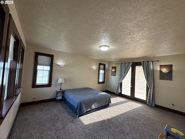 212 NW Bridge St, John Day, OR 97845 - carpeted bedroom featuring access to exterior, baseboards, and a textured ceiling