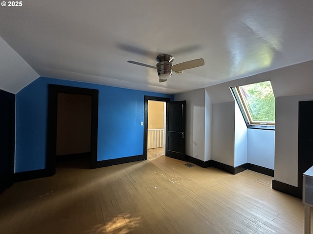 212 NW Bridge St, John Day, OR 97845 - unfurnished bedroom featuring vaulted ceiling, baseboards, light wood-style floors, and ceiling fan