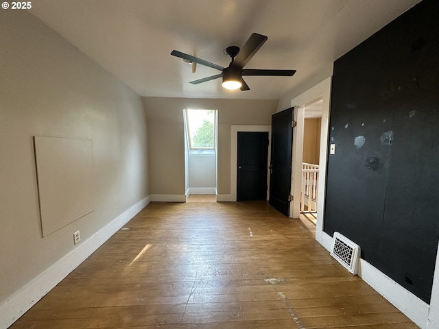 212 NW Bridge St, John Day, OR 97845 - unfurnished bedroom with hardwood / wood-style flooring, baseboards, and a ceiling fan