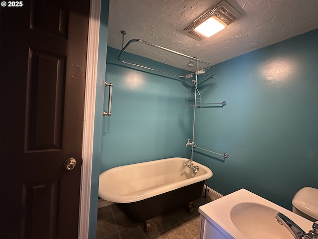 212 NW Bridge St, John Day, OR 97845 - bathroom featuring a textured ceiling, tile patterned flooring, and a sink