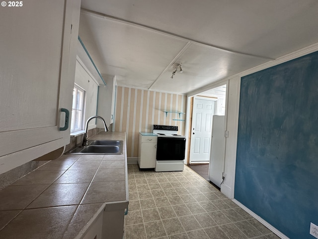 212 NW Bridge St, John Day, OR 97845 - kitchen featuring range with electric stovetop, a sink, tile countertops, white cabinetry, and baseboards