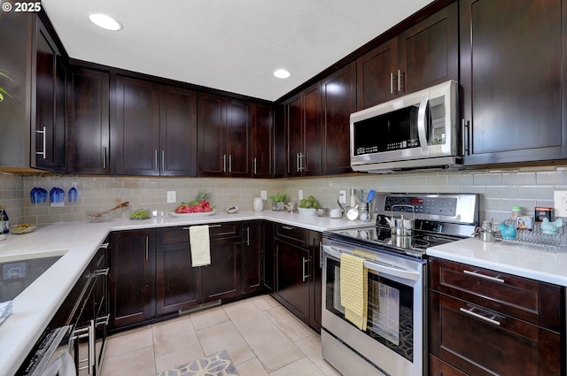 1364 Goodpasture Island Rd, Eugene, OR 97401 - kitchen featuring appliances with stainless steel finishes, light tile patterned floors, light countertops, backsplash, and dark brown cabinets