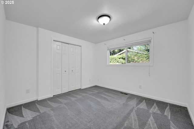 1364 Goodpasture Island Rd, Eugene, OR 97401 - unfurnished bedroom featuring dark carpet, baseboards, and a closet