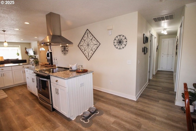 kitchen featuring island exhaust hood, electric stove, white cabinets, and visible vents