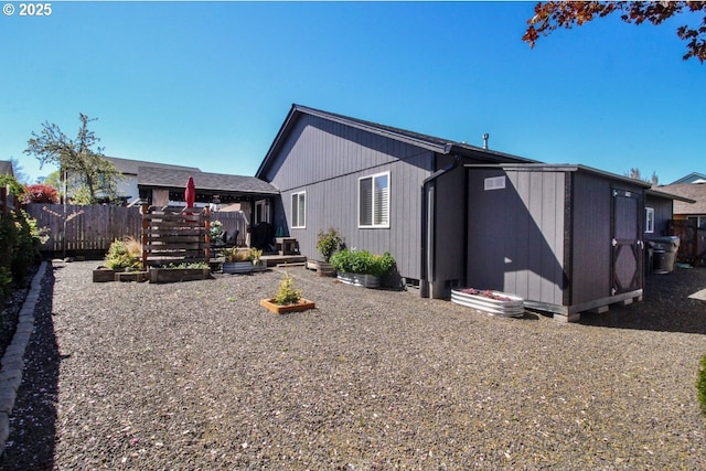 rear view of house featuring fence