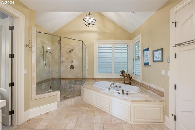 bathroom featuring lofted ceiling and plus walk in shower