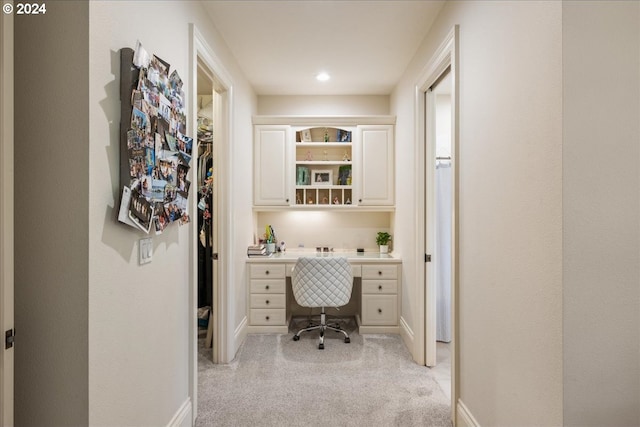 office with light carpet and built in desk