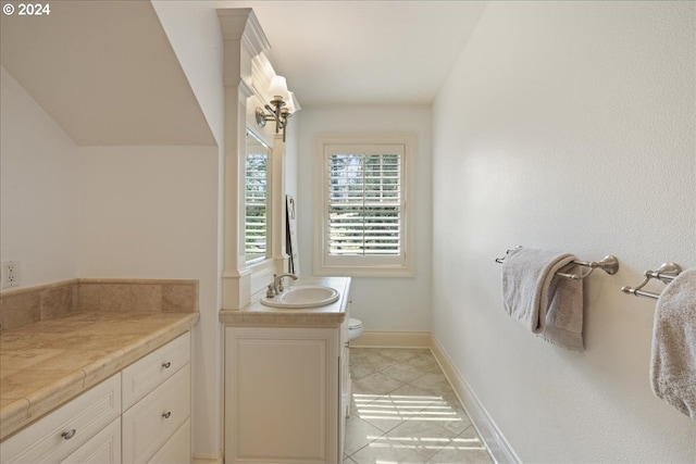 bathroom featuring toilet, vanity, and tile patterned floors