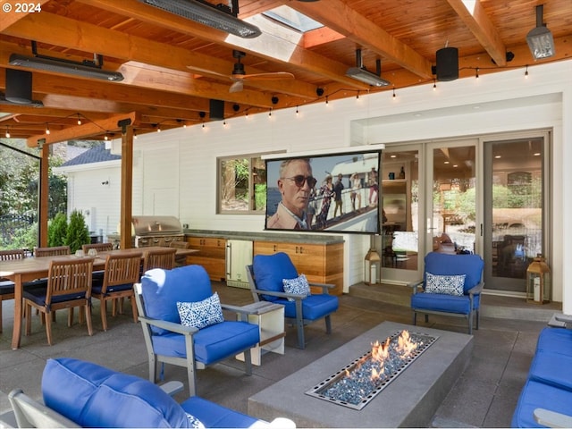 view of patio / terrace with ceiling fan, area for grilling, an outdoor fire pit, and exterior kitchen