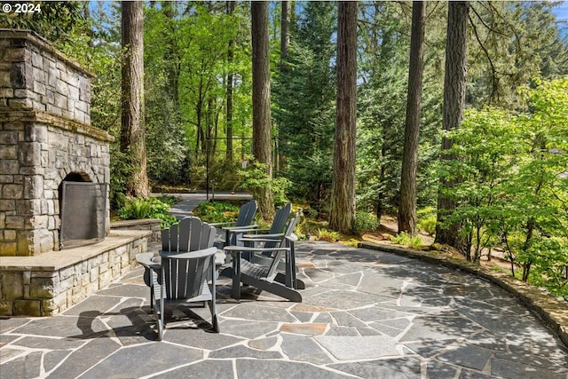 view of patio / terrace featuring an outdoor stone fireplace