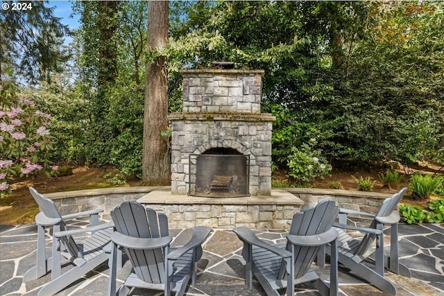 view of patio featuring an outdoor stone fireplace