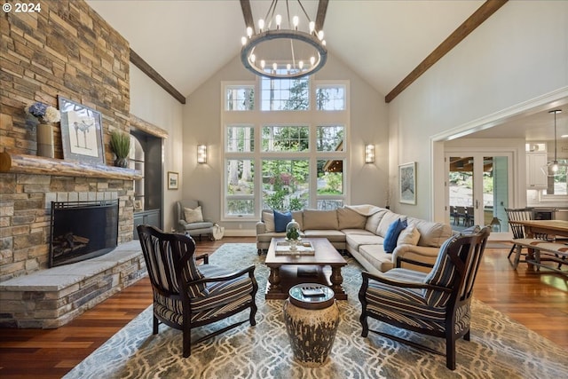 living room with a chandelier, a fireplace, hardwood / wood-style flooring, and high vaulted ceiling