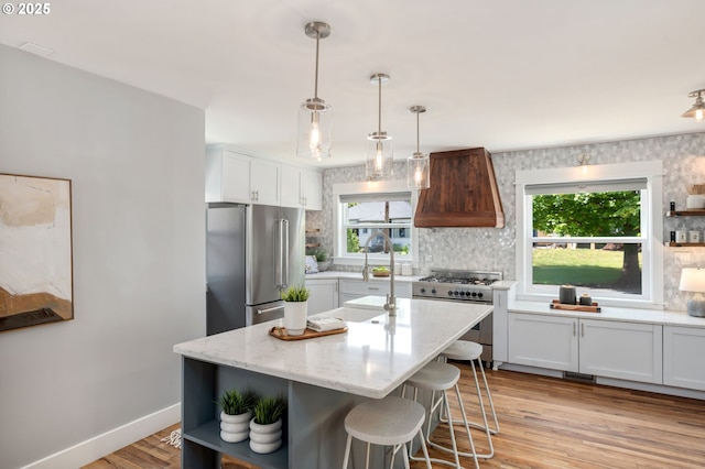6126 SE 23rd Ave, Portland, OR 97202 - kitchen with custom range hood, high end appliances, open shelves, and tasteful backsplash