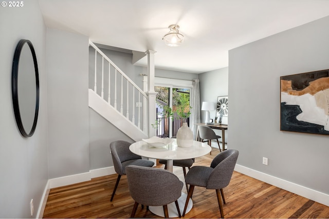 6126 SE 23rd Ave, Portland, OR 97202 - dining space featuring stairway, wood finished floors, and ornate columns