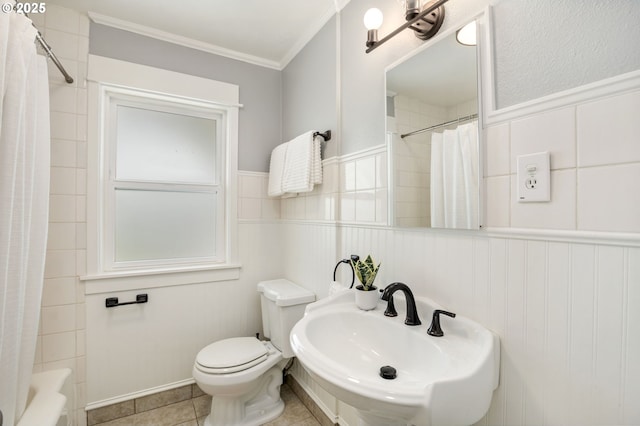6126 SE 23rd Ave, Portland, OR 97202 - bathroom featuring crown molding, a wainscoted wall, tile patterned flooring, and shower / tub combo