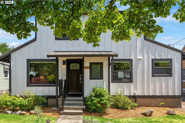 6126 SE 23rd Ave, Portland, OR 97202 - view of front of house featuring board and batten siding, a standing seam roof, and a metal roof