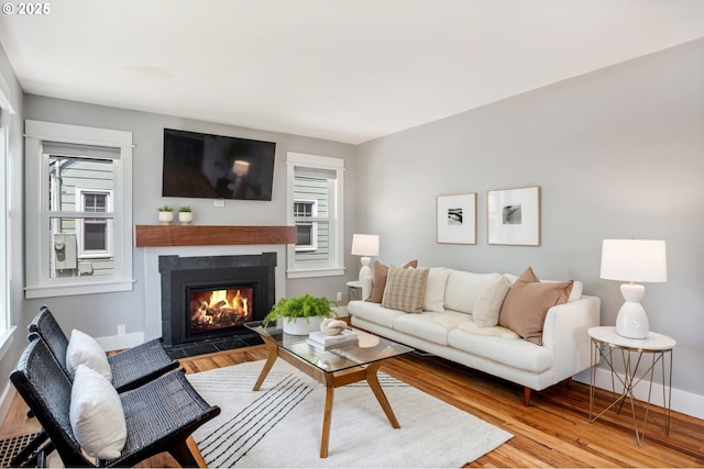 6126 SE 23rd Ave, Portland, OR 97202 - living room featuring wood finished floors and a fireplace with flush hearth