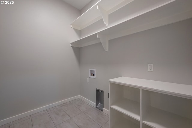 washroom featuring hookup for a washing machine and light tile patterned flooring