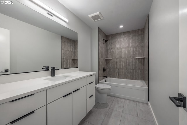 full bathroom with tile patterned flooring, vanity, toilet, and tiled shower / bath