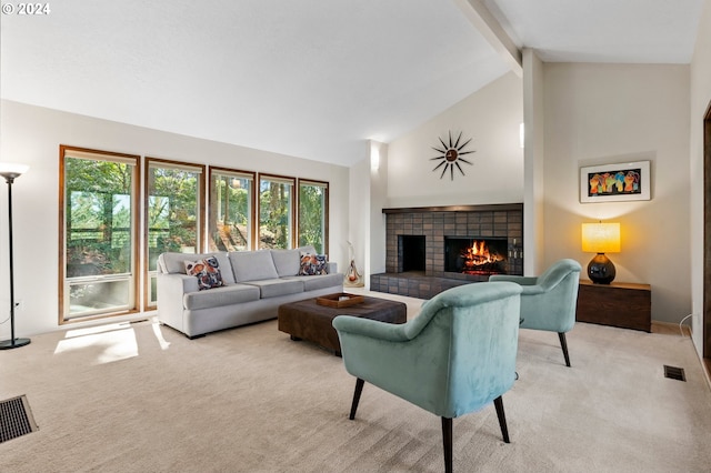 living area featuring light colored carpet, beamed ceiling, visible vents, and a fireplace