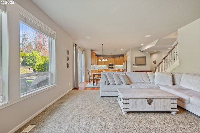 living room featuring visible vents, baseboards, a chandelier, recessed lighting, and stairs