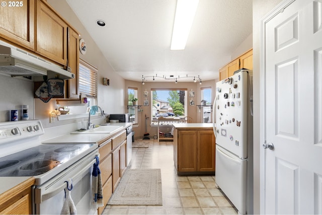 13810 NE 89th Cir, Vancouver, WA 98682 - kitchen featuring white appliances, a sink, under cabinet range hood, brown cabinetry, and light countertops