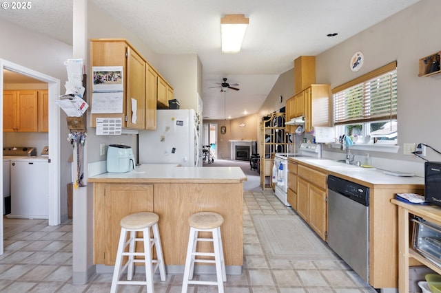 13810 NE 89th Cir, Vancouver, WA 98682 - kitchen with white appliances, independent washer and dryer, a sink, a ceiling fan, and a peninsula