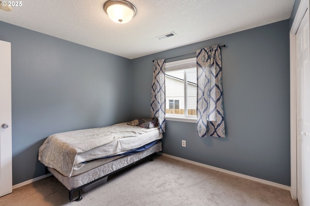 13810 NE 89th Cir, Vancouver, WA 98682 - bedroom featuring carpet floors, baseboards, a textured ceiling, and a closet