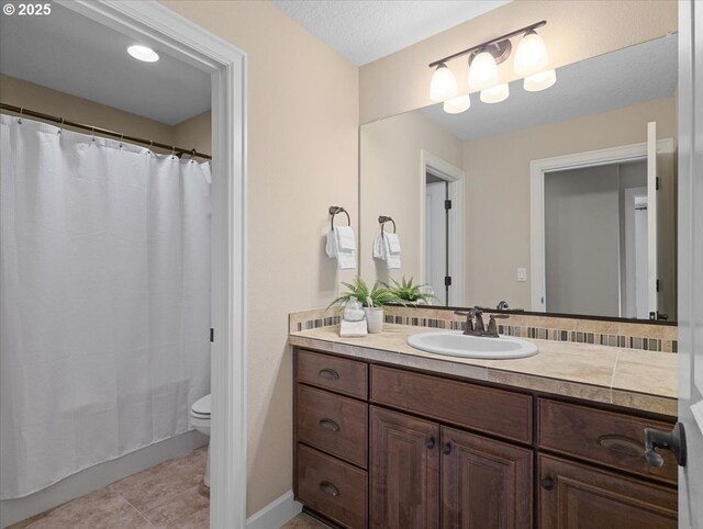 bathroom featuring curtained shower, toilet, tile patterned flooring, and vanity