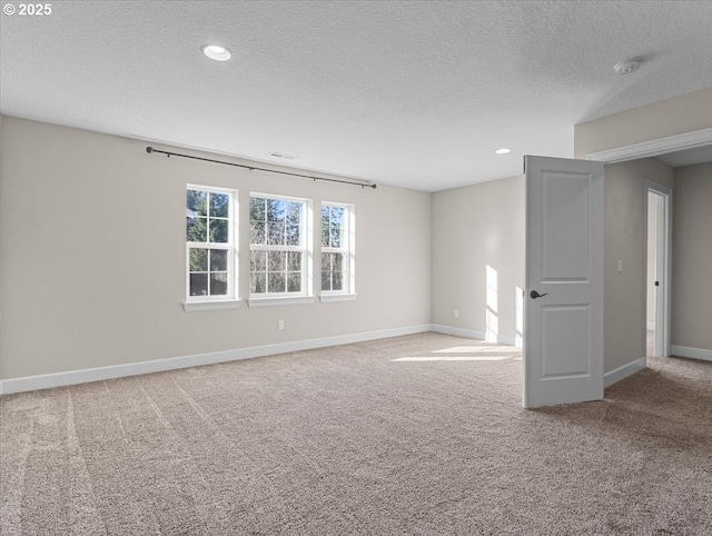 unfurnished room featuring baseboards, carpet floors, recessed lighting, and a textured ceiling