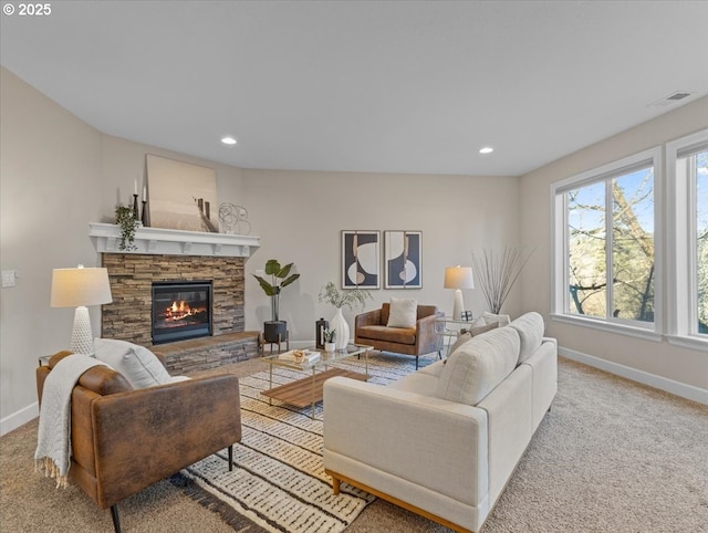 living room featuring a fireplace, light carpet, and a wealth of natural light