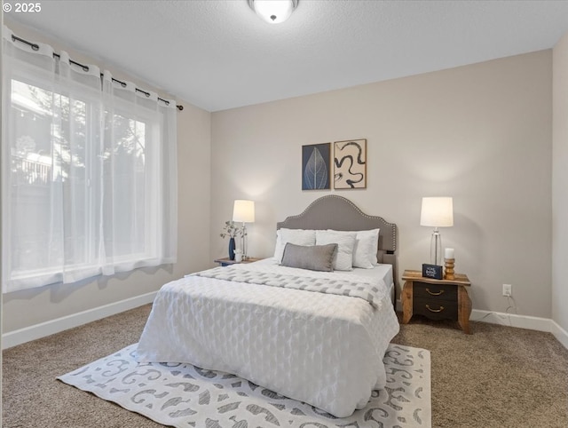 bedroom featuring carpet floors and a textured ceiling