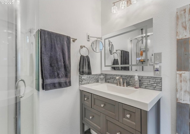 bathroom with decorative backsplash, vanity, and a stall shower