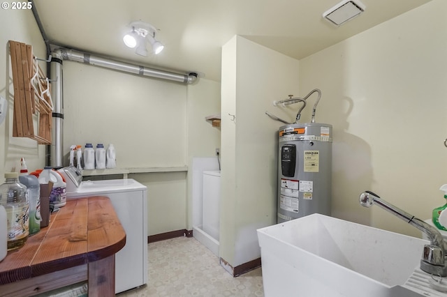 laundry area featuring laundry area, a sink, electric water heater, tile patterned floors, and independent washer and dryer