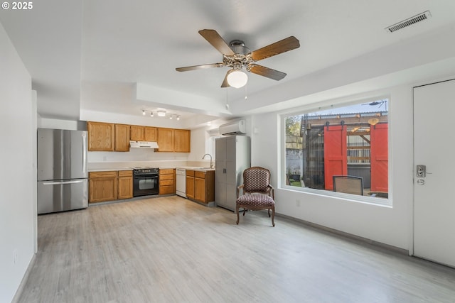 kitchen with visible vents, white dishwasher, freestanding refrigerator, light countertops, and black range with electric stovetop