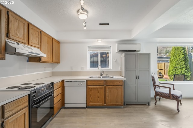 kitchen featuring a wall mounted AC, white dishwasher, a sink, black range with electric cooktop, and under cabinet range hood