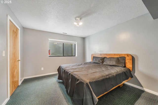 bedroom with a textured ceiling, baseboards, and carpet floors