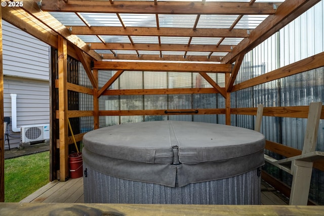 wooden deck with ac unit and a hot tub