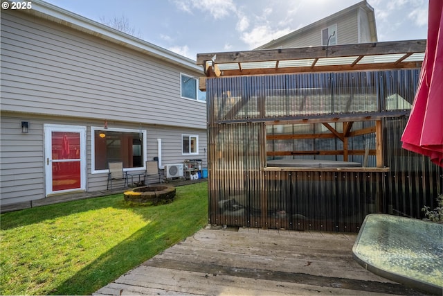 deck with a lawn and an outdoor fire pit