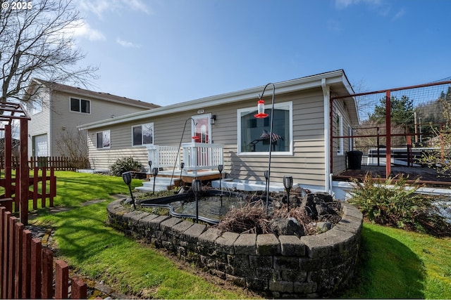 view of front of house with a front lawn and fence