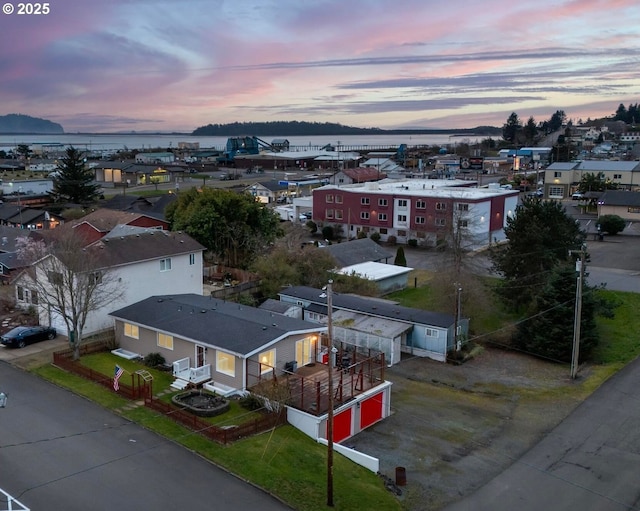 aerial view at dusk with a water view