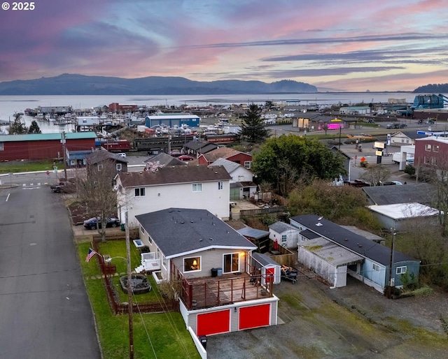 aerial view at dusk featuring a mountain view