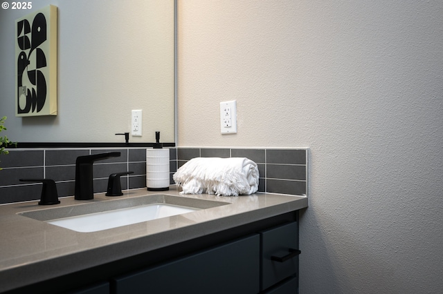 bathroom with vanity and tasteful backsplash