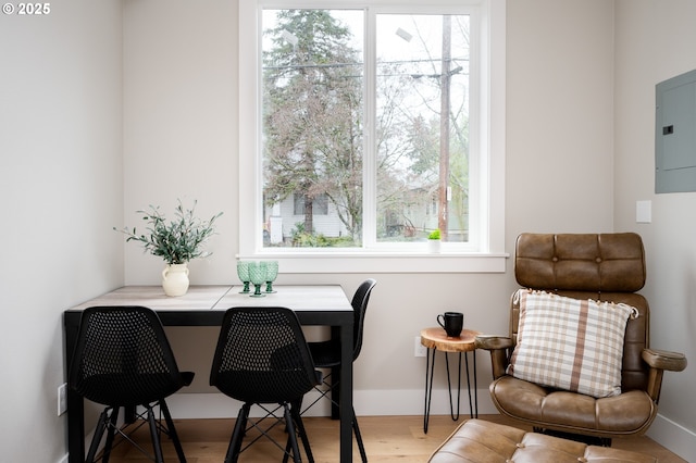 interior space with electric panel and hardwood / wood-style flooring