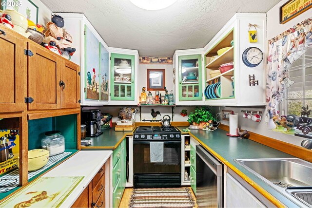 1042 W State Route 4, Cathlamet, WA 98612 - kitchen with brown cabinets, a sink, dishwasher, a textured ceiling, and black range with gas cooktop