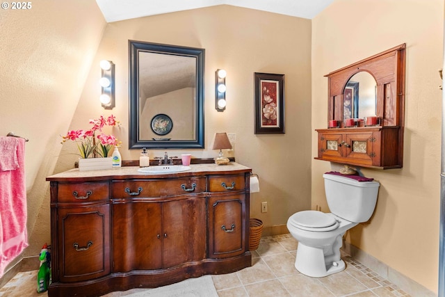 1042 W State Route 4, Cathlamet, WA 98612 - bathroom featuring vanity, lofted ceiling, toilet, baseboards, and tile patterned floors