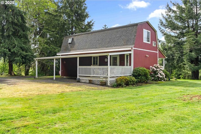 1042 W State Route 4, Cathlamet, WA 98612 - rear view of house featuring a lawn, a gambrel roof, roof with shingles, and covered porch