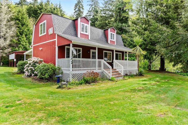 1042 W State Route 4, Cathlamet, WA 98612 - view of front facade with covered porch, a gambrel roof, a shingled roof, and a front lawn